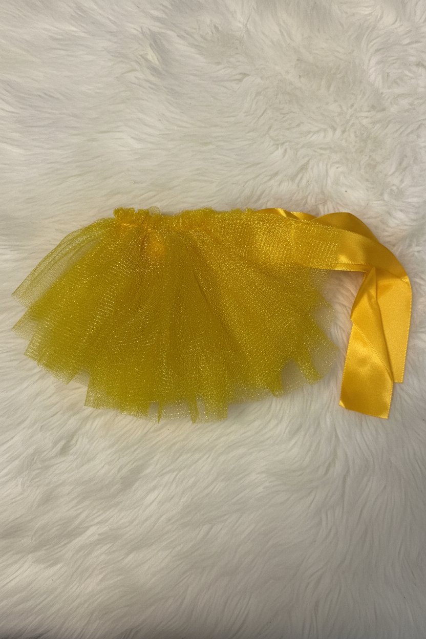Yellow tutu skirt with a ribbon on a white fur background
