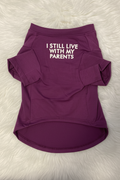 Purple pet shirt with text 'I STILL LIVE WITH MY PARENTS' on a white fur background