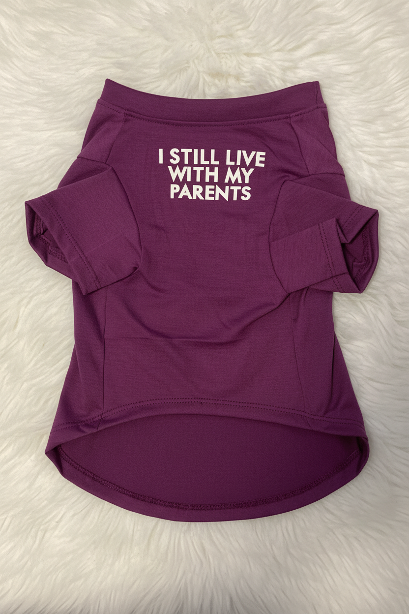 Purple pet shirt with text 'I STILL LIVE WITH MY PARENTS' on a white fur background