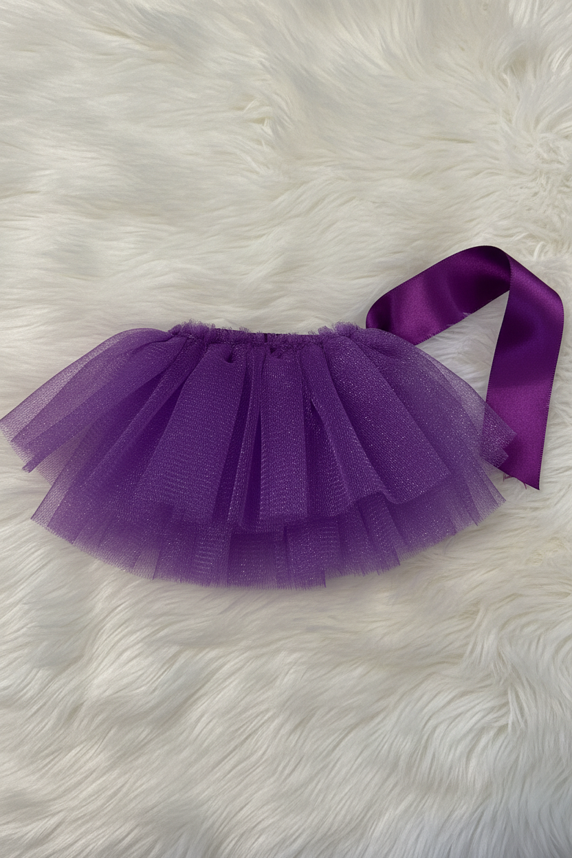 Purple tutu skirt with a ribbon on a white fluffy surface