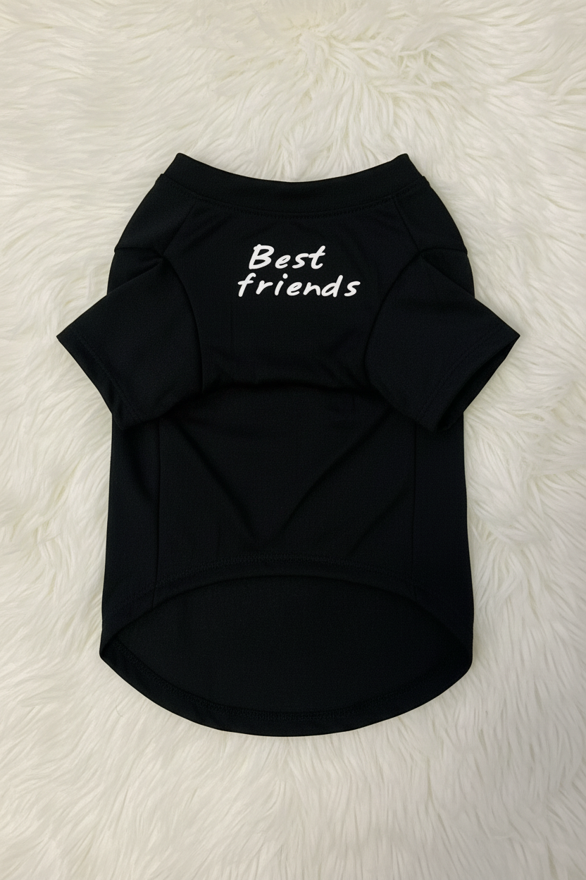 Black pet shirt with 'Best friends' text on a white fluffy surface