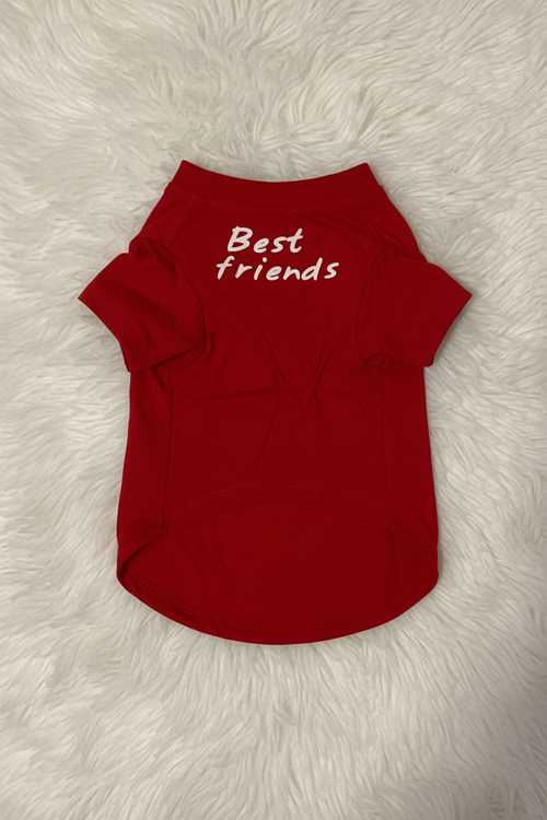 Red pet shirt with 'Best friends' text on a fluffy white surface