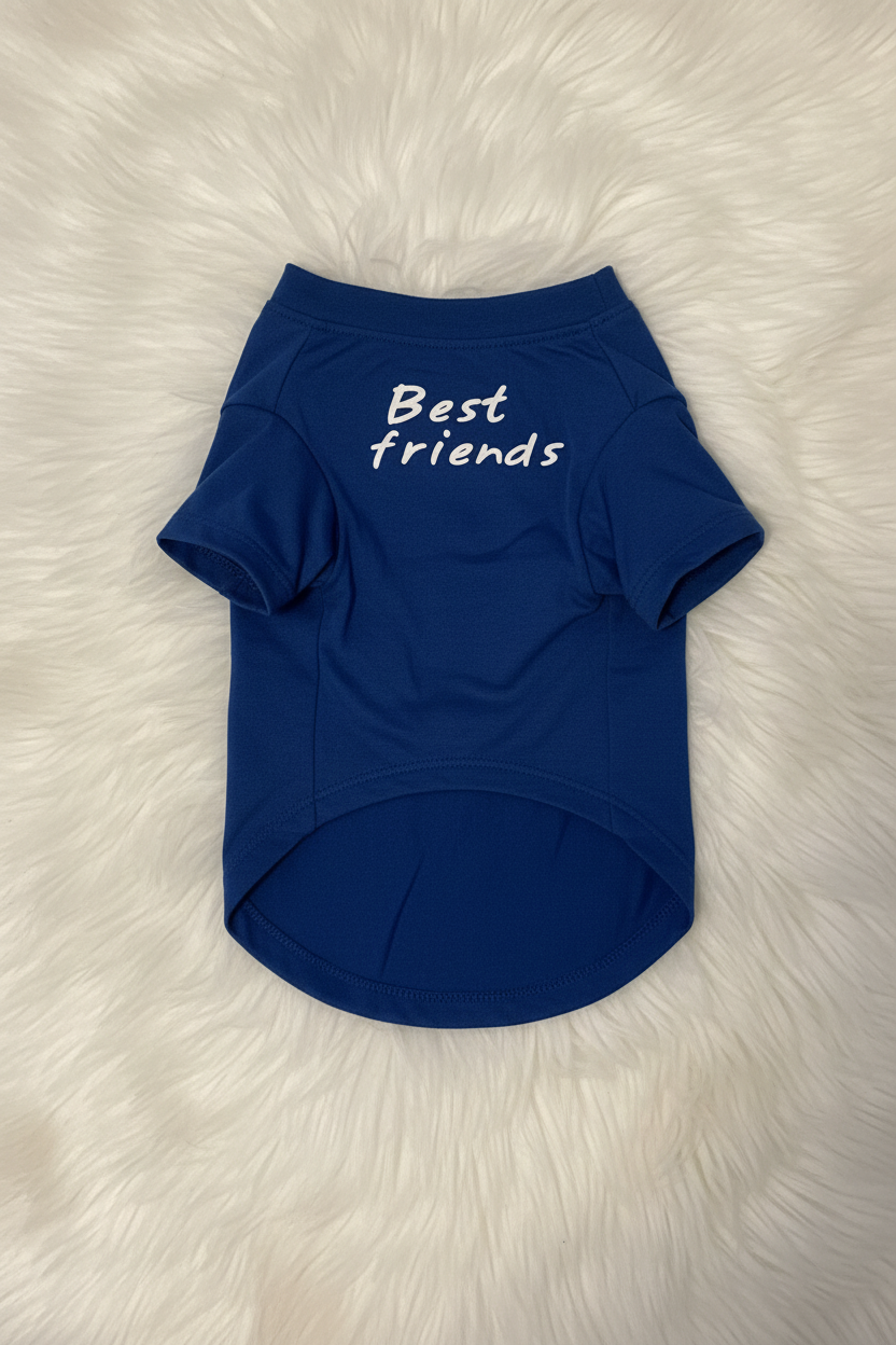 Blue pet shirt with 'Best friends' text on a fluffy white surface