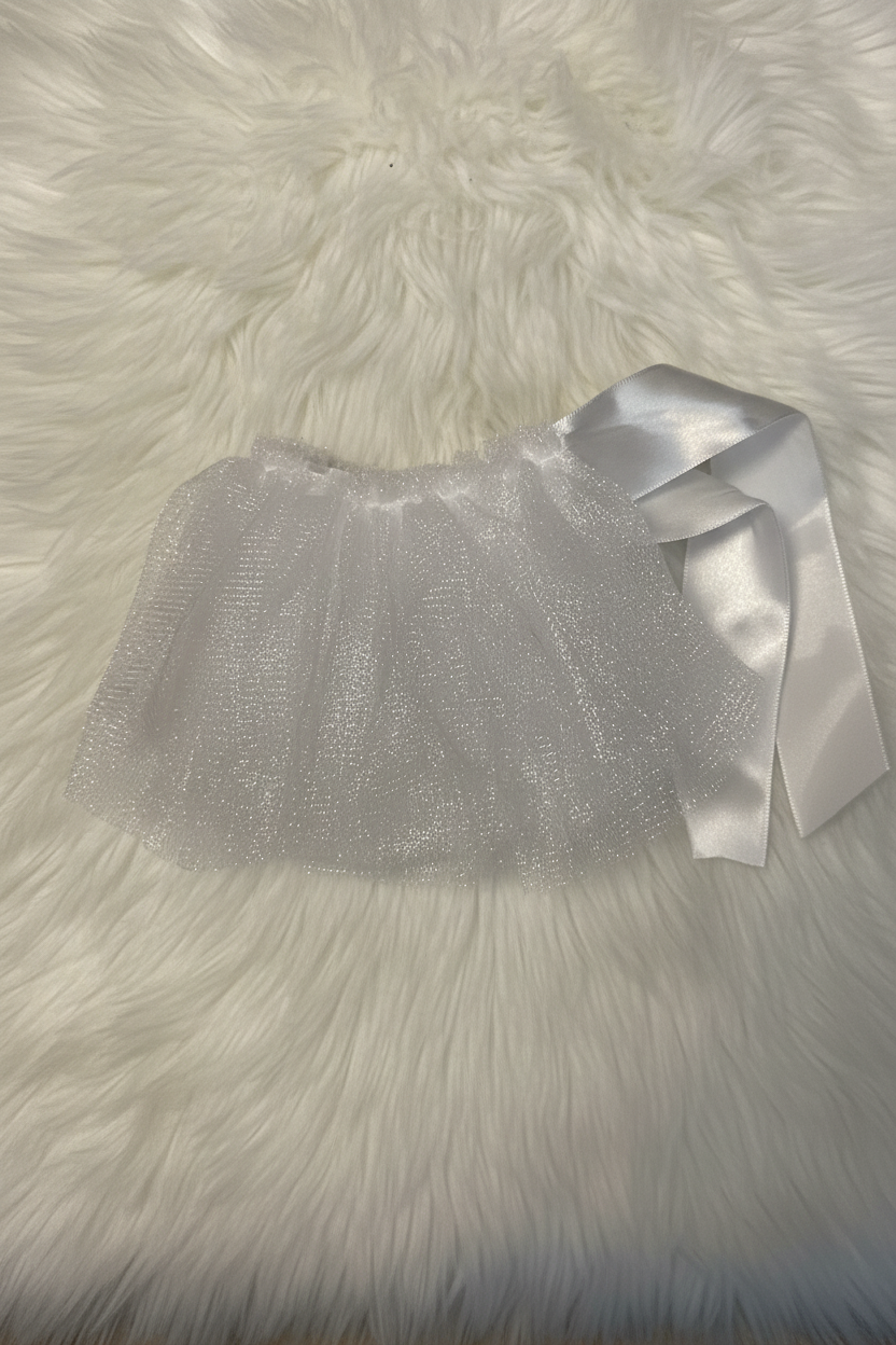White tutu with a satin ribbon on a fluffy white surface