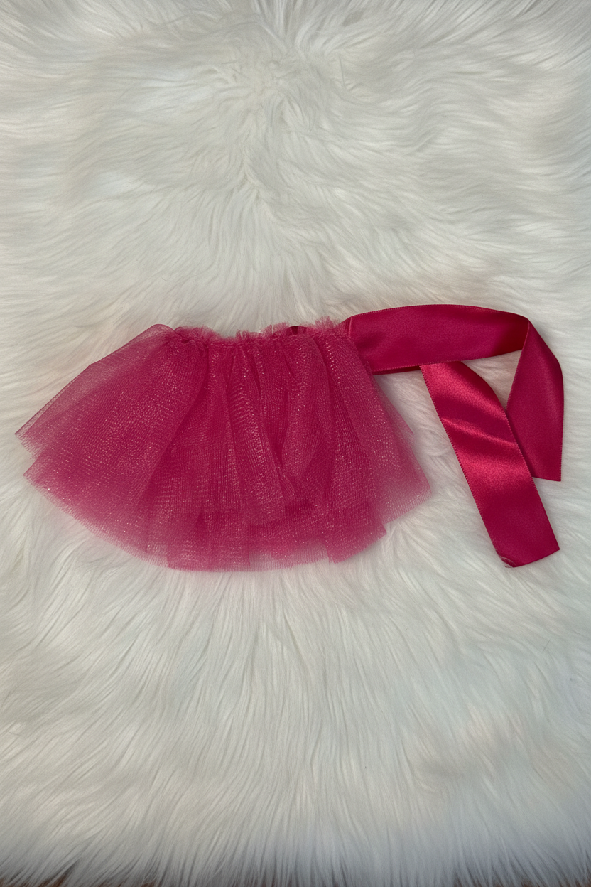 Pink tutu skirt with a ribbon on a white fur surface
