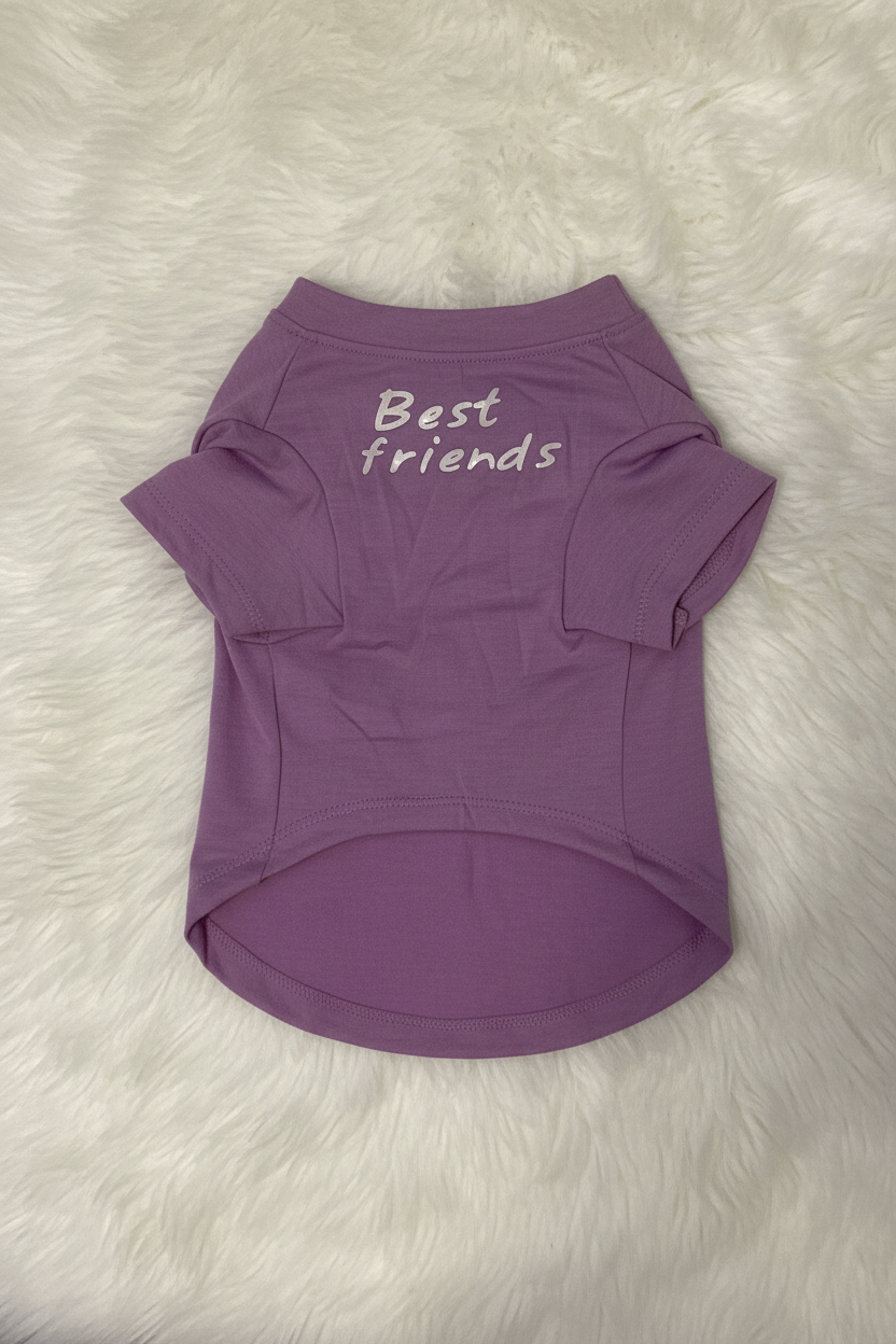 Purple pet shirt with 'Best friends' text on a white fur background