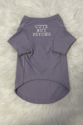 Purple dog shirt with 'Cute But Psycho' text on a white fur background