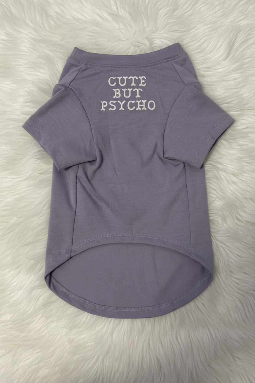 Purple dog shirt with 'Cute But Psycho' text on a white fur background